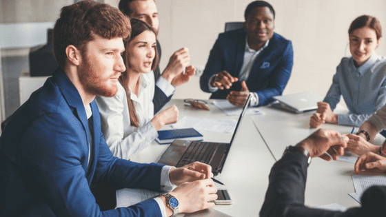 young professional employees listening to boss teach digital marketing