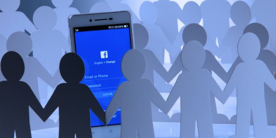 Group of paper people surrounding a Facebook Algorithm change on a mobile phone.