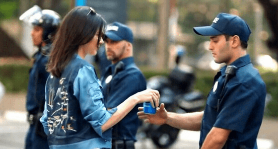kendall jenner handing pepsi to police officer in poorly written pepsi ad