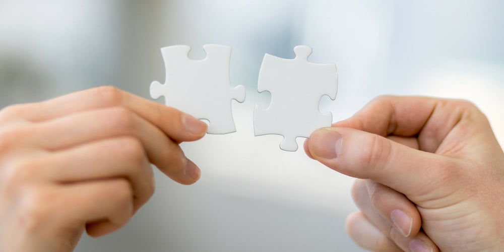 software integration for small business accounting software represented by two white puzzle pieces fitting together.