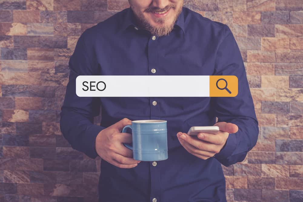 Search bar and man with mobile phone looking for WordPress SEO Checklist