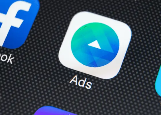 - digital marketing for growing businesses by honeypot marketing facebook ad icon on mobile device next to main facebook and twitter applications